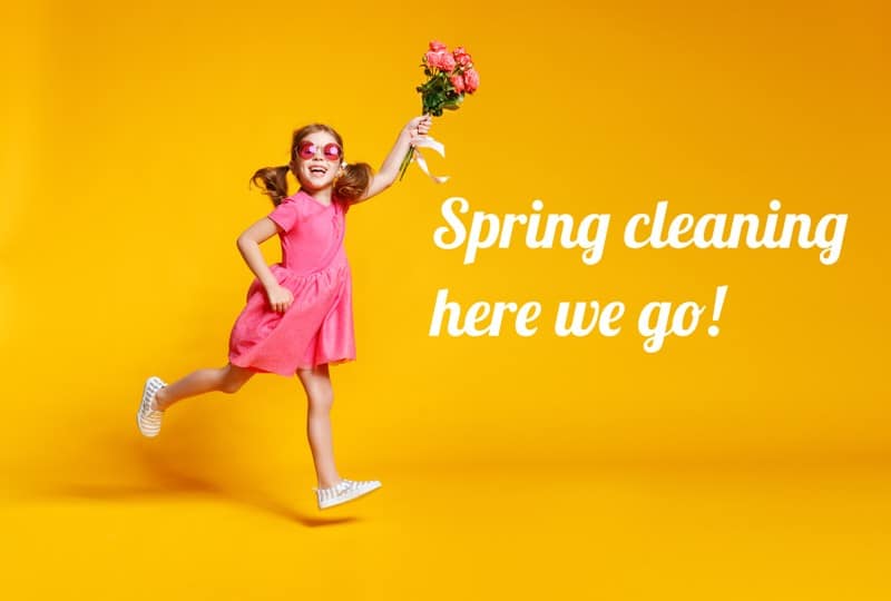 girl in pink dress with flowers saying spring cleaning here we go