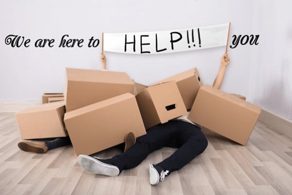 cardboard boxes fallen on people with caption we are here to help you