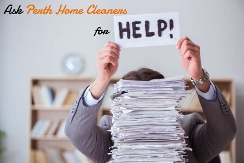 man in a grey suit, hiding behind a stack of paperwork so only his arms and the top of his head is visible. The caption reads ask Perth Home Cleaners for help. The word help is on a piece of paper held up by the man in the suit