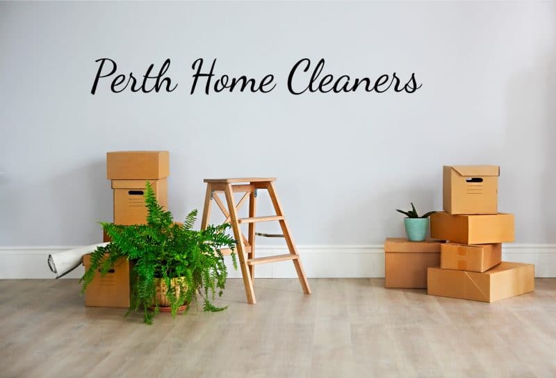 A spotless room with two piles of brown boxes against the wall, a step ladder and a potted plant. The words Perth Home Cleaners on the wall